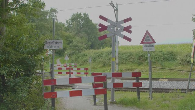 Wide shot of unguarded level crossing in the Netherlands