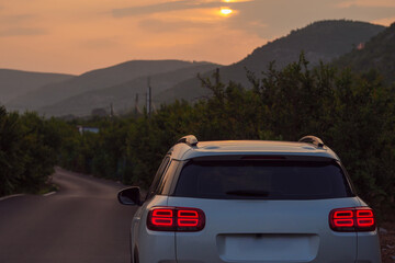 Obraz na płótnie Canvas Evening sunset and cars