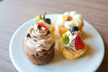 Delicious cupcakes on white plate