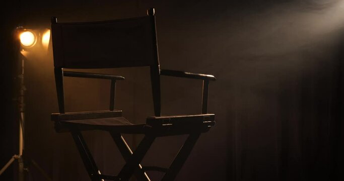 Empty director's chair on a smoky film set