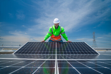 Engineer wearing unifrom and helmet inspect and check solar cell panel ,solar cell is ecology...