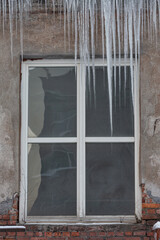 long icicles on white window