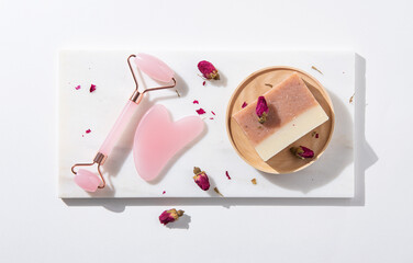  flat lay with natural cosmetic products  soap and pink gua sha  on white background. Top view and copy space