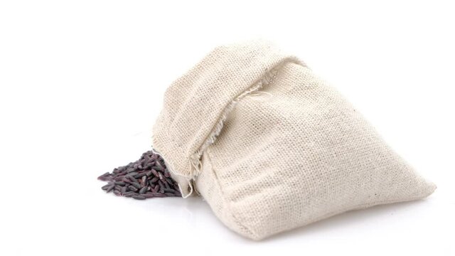 Rotation shot of Black rice berry in bag on white background,Close up.	