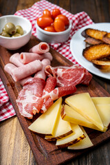 Cheese and cold cuts table, cherry tomatoes, olives.