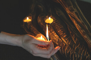 The girl lights candles with matches