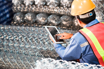 Foreman inspecting wire rods at the wire rod factory in steel industry and construction in Asian...