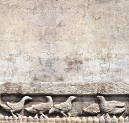Fototapeta na wymiar Retro background with ancient wall carving with birds
