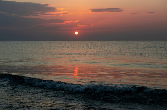 A sunrise seen from the beach of the sea