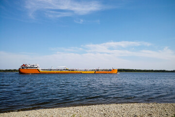 Barge with tanks for oil products floating on the river