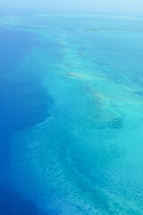 Fototapeta na wymiar The Caribbean Sea with a beautiful blue gradation seen from the sky