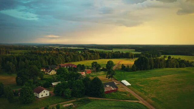 Scenic Wooden Homes On Countryside At Sunset In Hjo, Vastra Gotaland County, Sweden. - Aerial Wide Shot