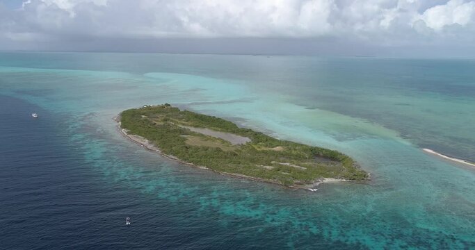 Moving turn left to rigth Cote barrier reef aerial view cay  and shallow turquoise waters in Los Roques venezuela,  blue water and Green mangrove