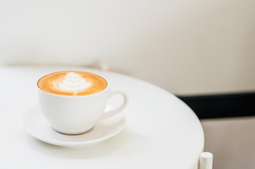 Hot coffee with Latte art and white mug on white background.Copy space for your design concept