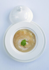 braised superior whole shark's fin thick soup with golden stock seafood in white background asian halal menu