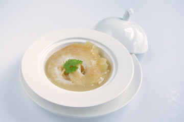 braised superior whole shark's fin thick soup with golden stock seafood in white background asian halal menu