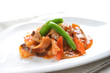stir fried octopus squid with vegetable in spicy sambal chili sauce seafood in white background asian halal menu