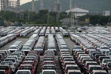 Row of new cars for sale in port. New automobiles background