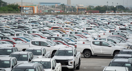 Row of new cars for sale in port. New automobiles background