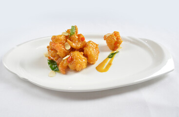 wok fried seafood prawn in pumpkin salted egg yolk sauce in white background asian halal menu