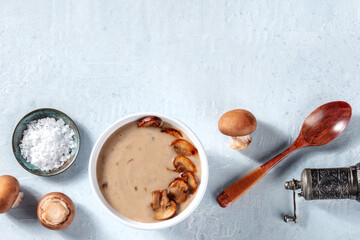Cooking mushroom soup, top shot with copy space. Raw mushrooms and condiments in a kitchen