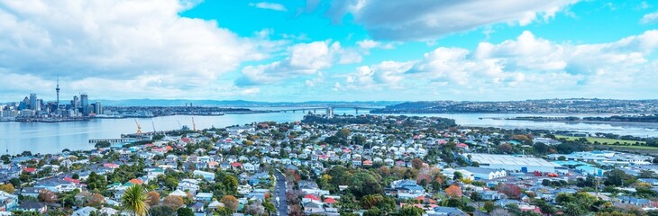 stunning skyline view of Auckland cityscape with Auckland Harbour bridge at the far end, photo taken from Mount Vitoria lookout view point located in seaside village of Devonport