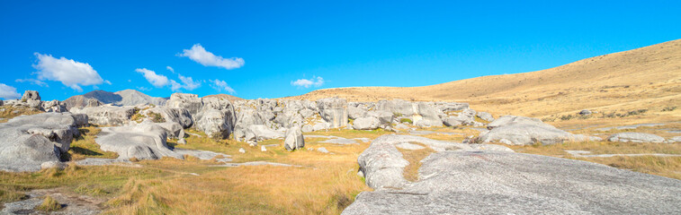 panoramic view of Castle Hill on sunshine day. Majestic limestone rock formations at Castle Hill, Canterbury, South Island of New Zealand.