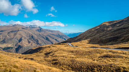 Naklejka premium The Crown Range lies between Queenstown and Wanaka. The road over the range, known as the Crown Range Road, is the highest main road in New Zealand.