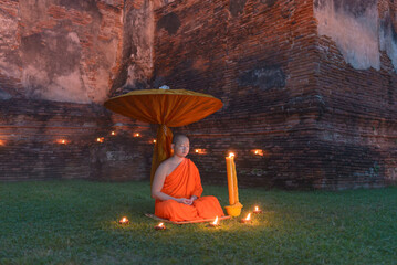 Buddhist monks meditate to calm the mind on during sunset, Thailand