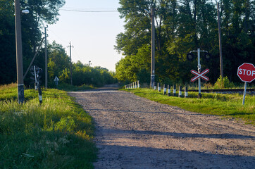 Railroad crossing and stop sign in countryside