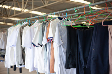 Hang clothes on a hanger.