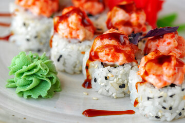 Japanese sushi with sesame seeds and cream icing on gray background