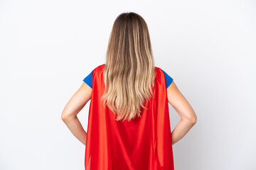 Young Romanian woman isolated on white background in superhero costume in back position © luismolinero
