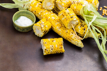 Grilled corn sliced. Grilled corn cobs with leaves