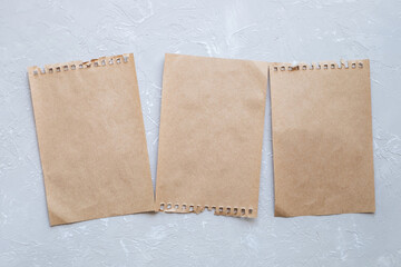 Top view of closed craft paper notebook sheets on gray background. Minimalistic eco life