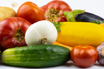 An assortment of fresh vegetables isolated on a white background.
