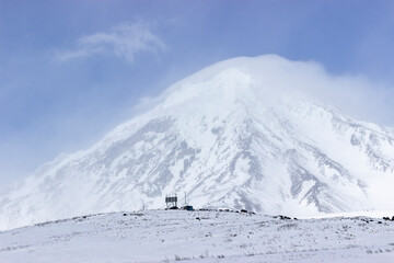 Russia, Natural Park "volcanoes of Kamchatka". The koryaksky volcano covered with snow and clouds on its rocks. The perfect weather for climbing. interesting and affordable for the tourists