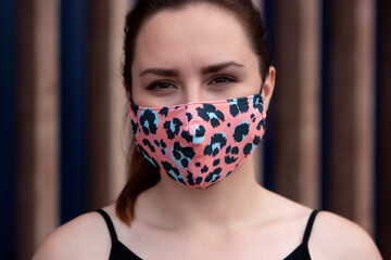 Close up portrait of beautiful woman in colorful protective mask