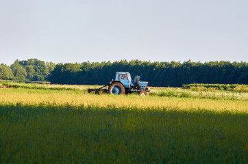 Old tractor plowing the field