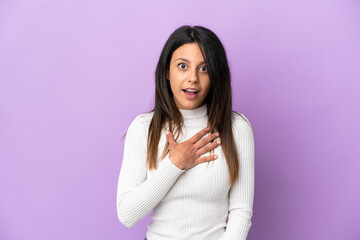 Young caucasian woman isolated on purple background surprised and shocked while looking right