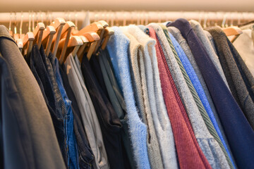 Clothes of all colors inside a cloakroom
