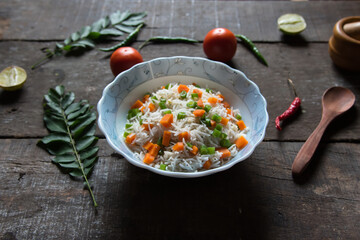 Vegetable pulao or flavoured rice mix with vegetables served in a bowl. Close up.