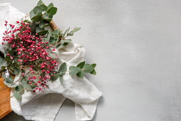 Flower composition on a white background. Bouquet of gypsophila and eucalyptus with fabric on texture, top view