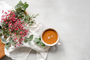Lifestyle concept - cup with coffee and flowers on a white background. Flat, top view, place for text