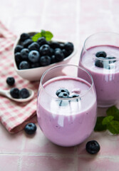 Glasses of blueberry yogurt with blueberries
