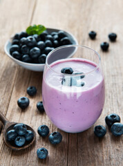Glass of blueberry yogurt with blueberries