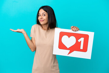 Young woman over isolated background holding a placard with Like icon with surprised expression