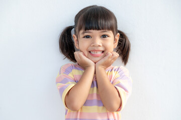 Portrait of happy smiling child girl isolated on white background