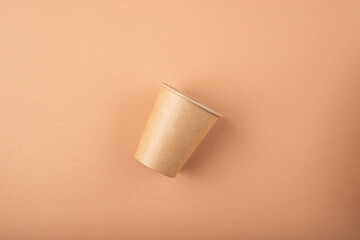 Eco friendly kitchen items . Zero waste and plastic free concept. Cup in top view on beige background. Disposable tableware. Natural products for recycle .