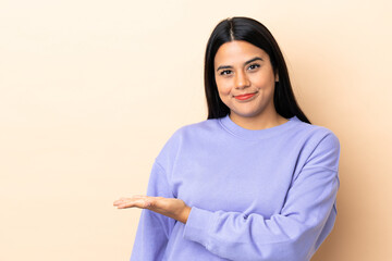 Young latin woman woman over isolated background presenting an idea while looking smiling towards